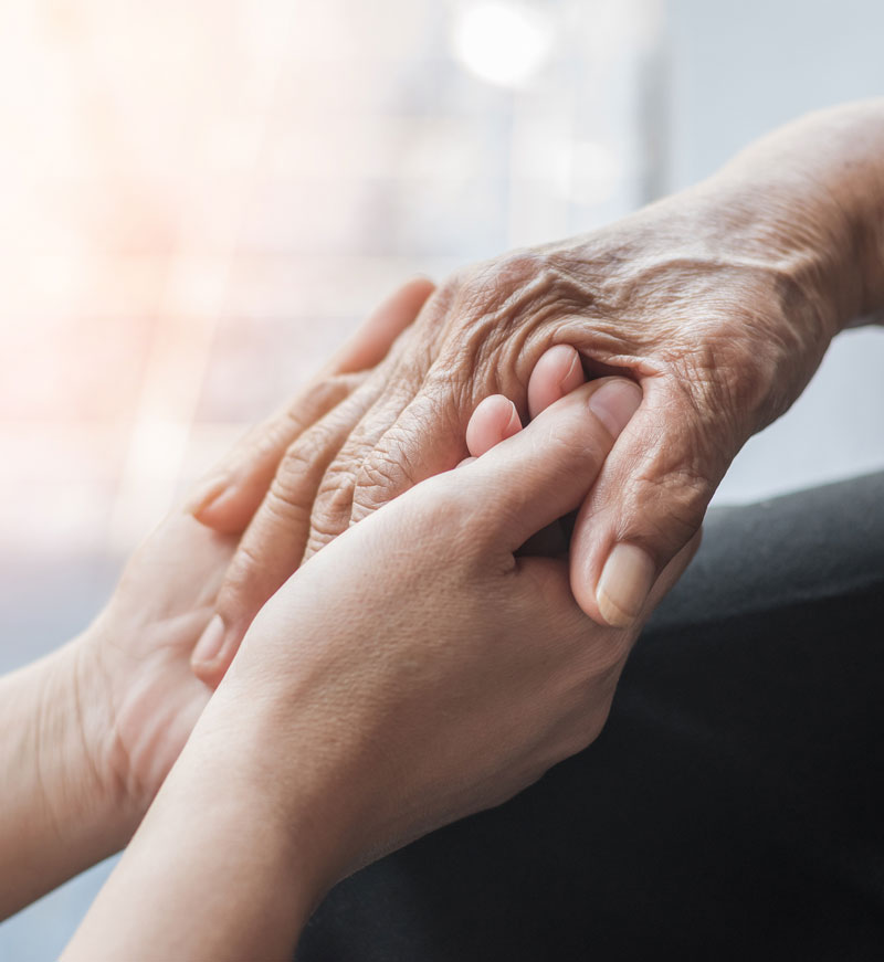 team member holding residents hand