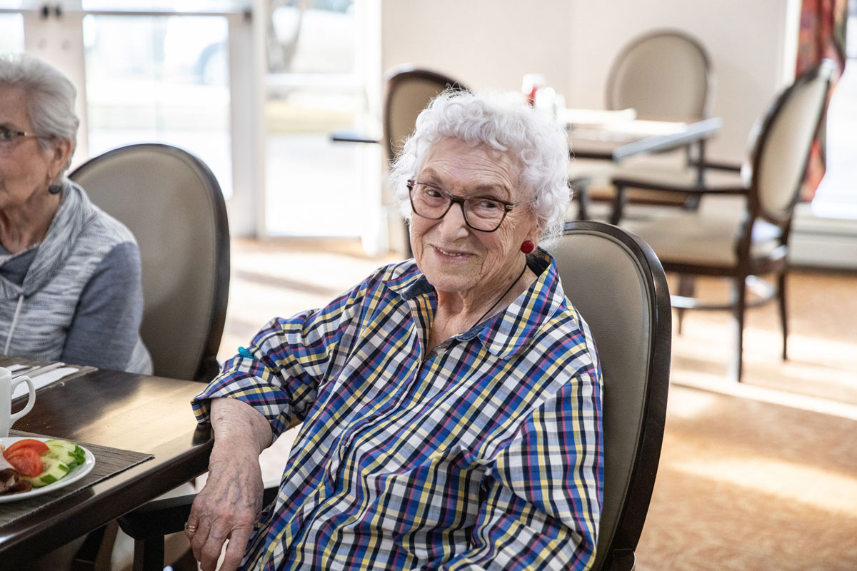 smiling resident sitting at table