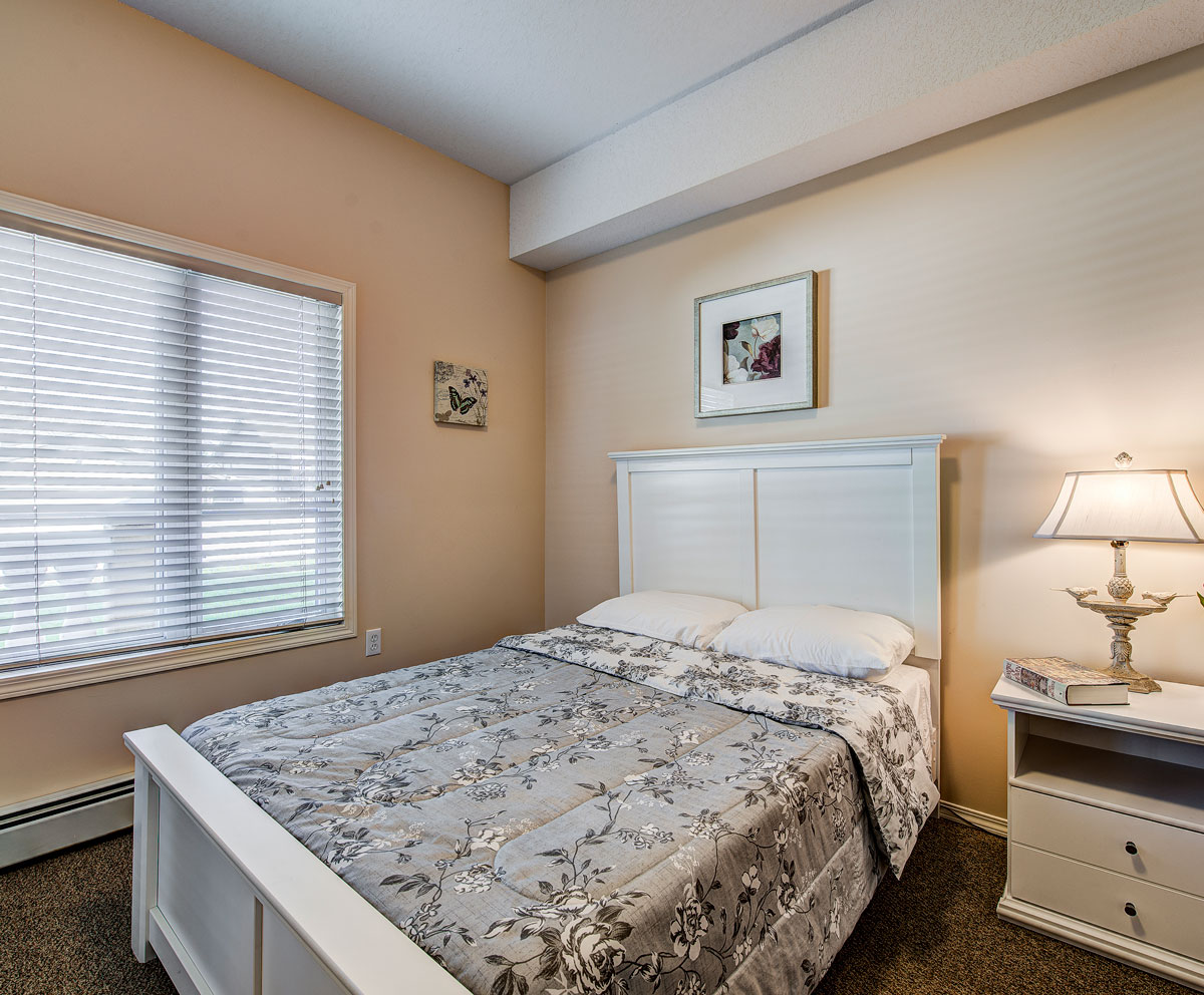suite bed with nighstand and window